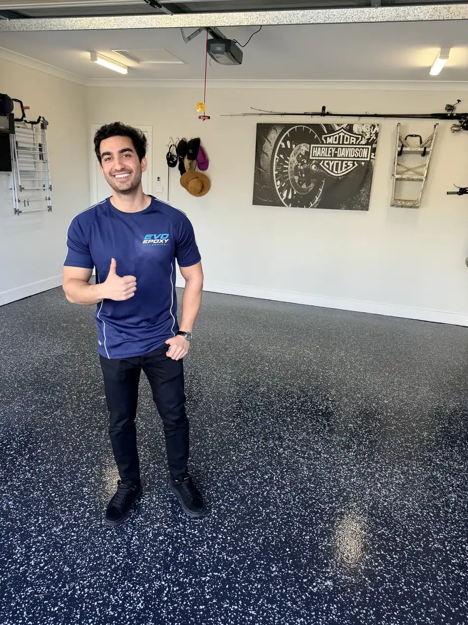 Evo Epoxy Flooring founder on a finished flake epoxy garage floor