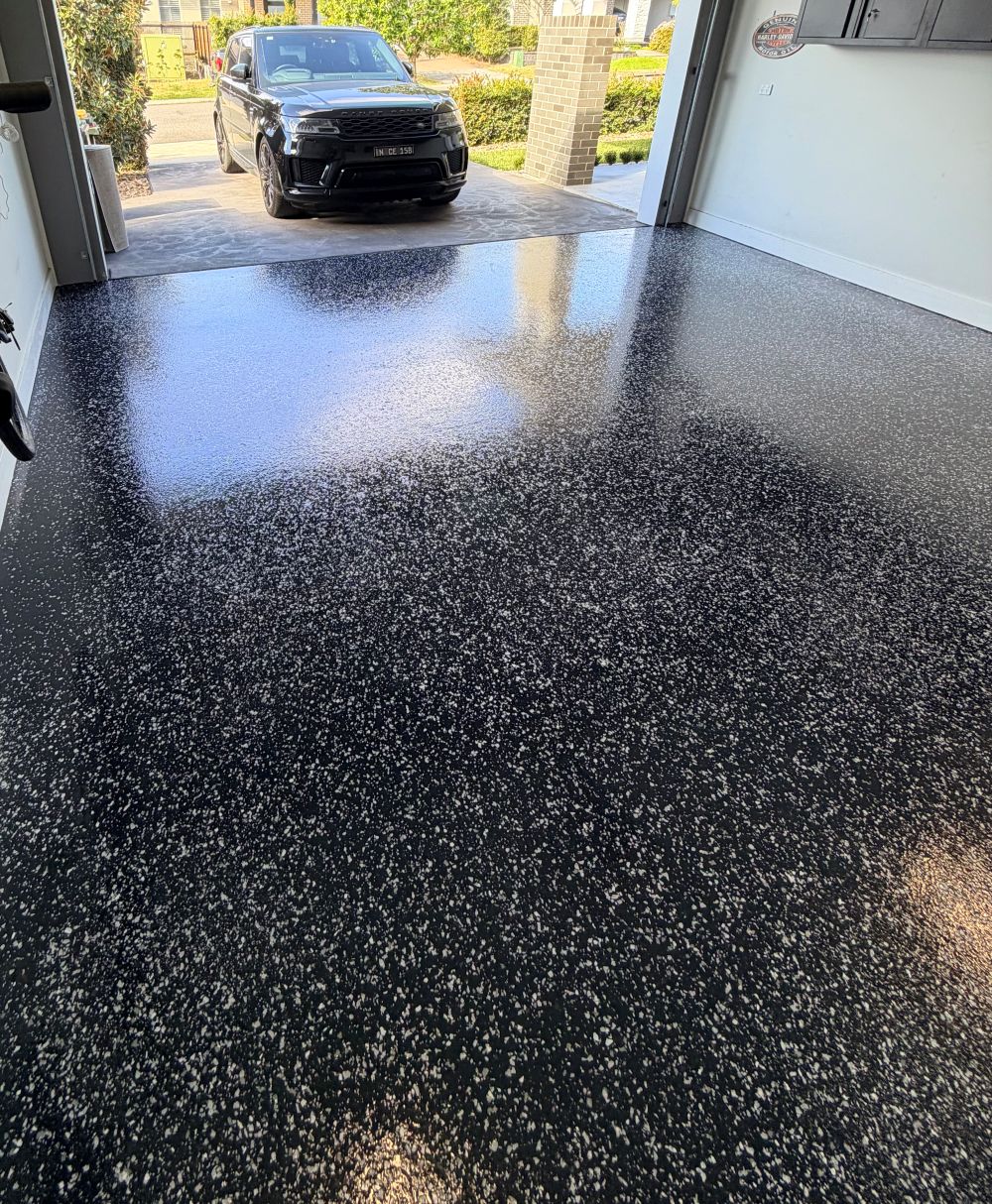 Finished black flake epoxy garage floor by Evo Epoxy Flooring