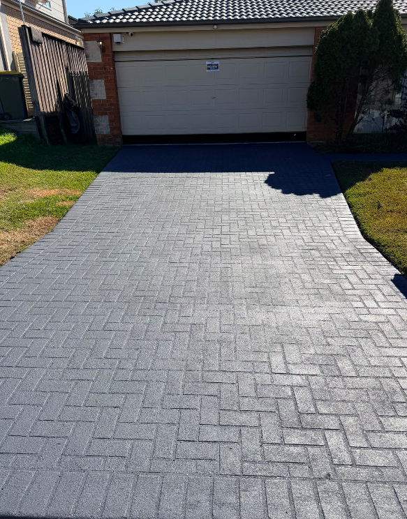 The same driveway after grinding and sealing in grey