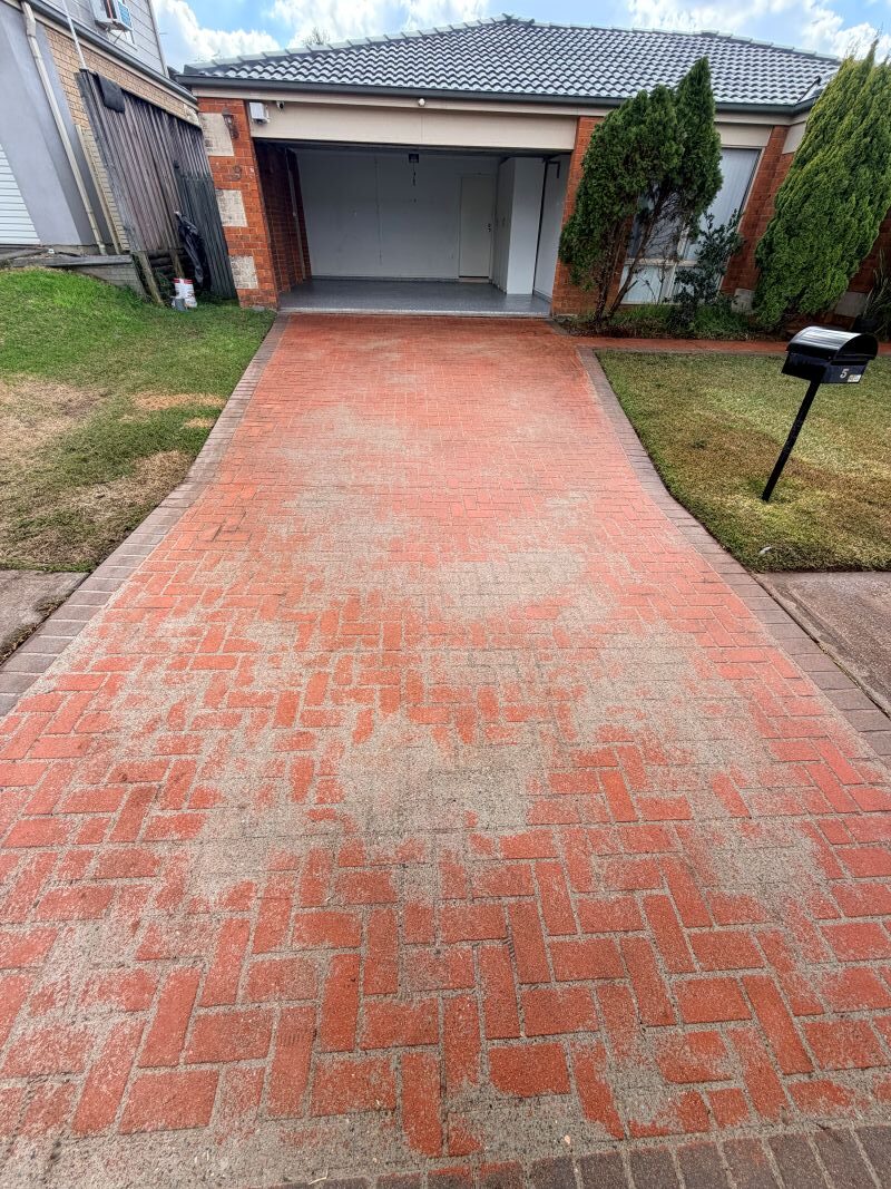 Tired stained driveway before grinding and sealing