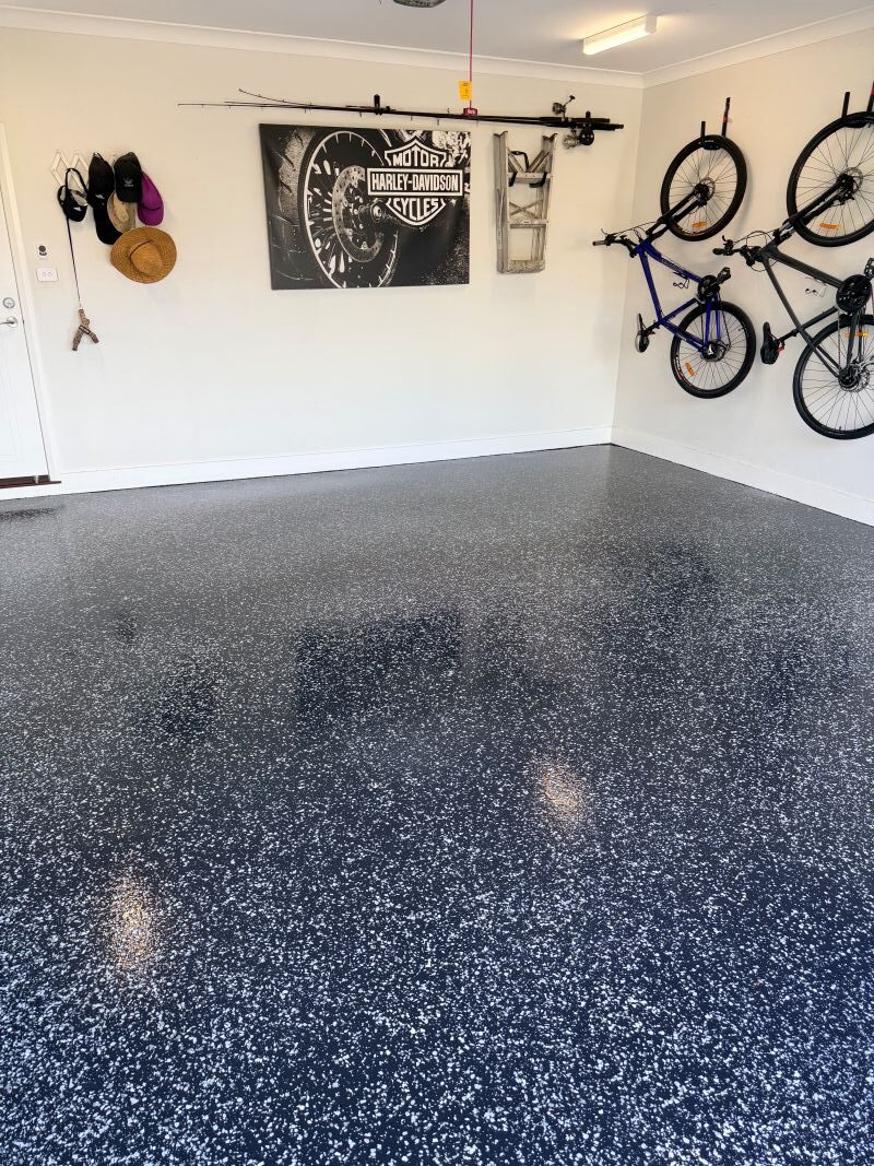 Finished dark flake epoxy garage floor by Evo Epoxy