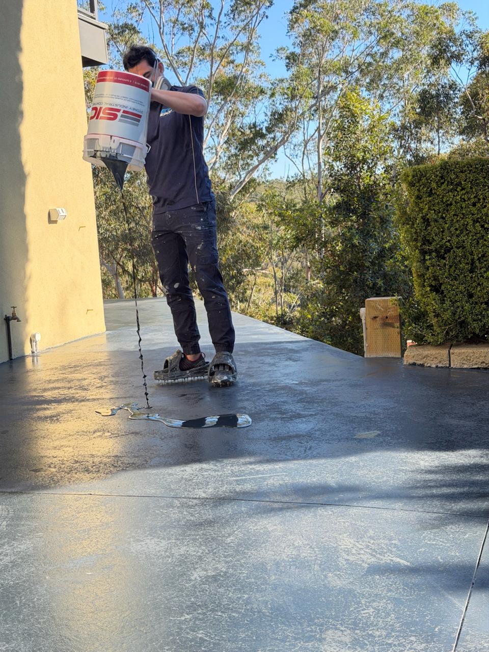 Evo Epoxy applying concrete sealer to an outdoor slab in Sydney