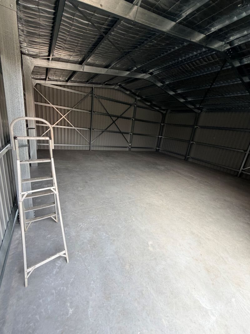 Bare concrete shed floor before epoxy coating